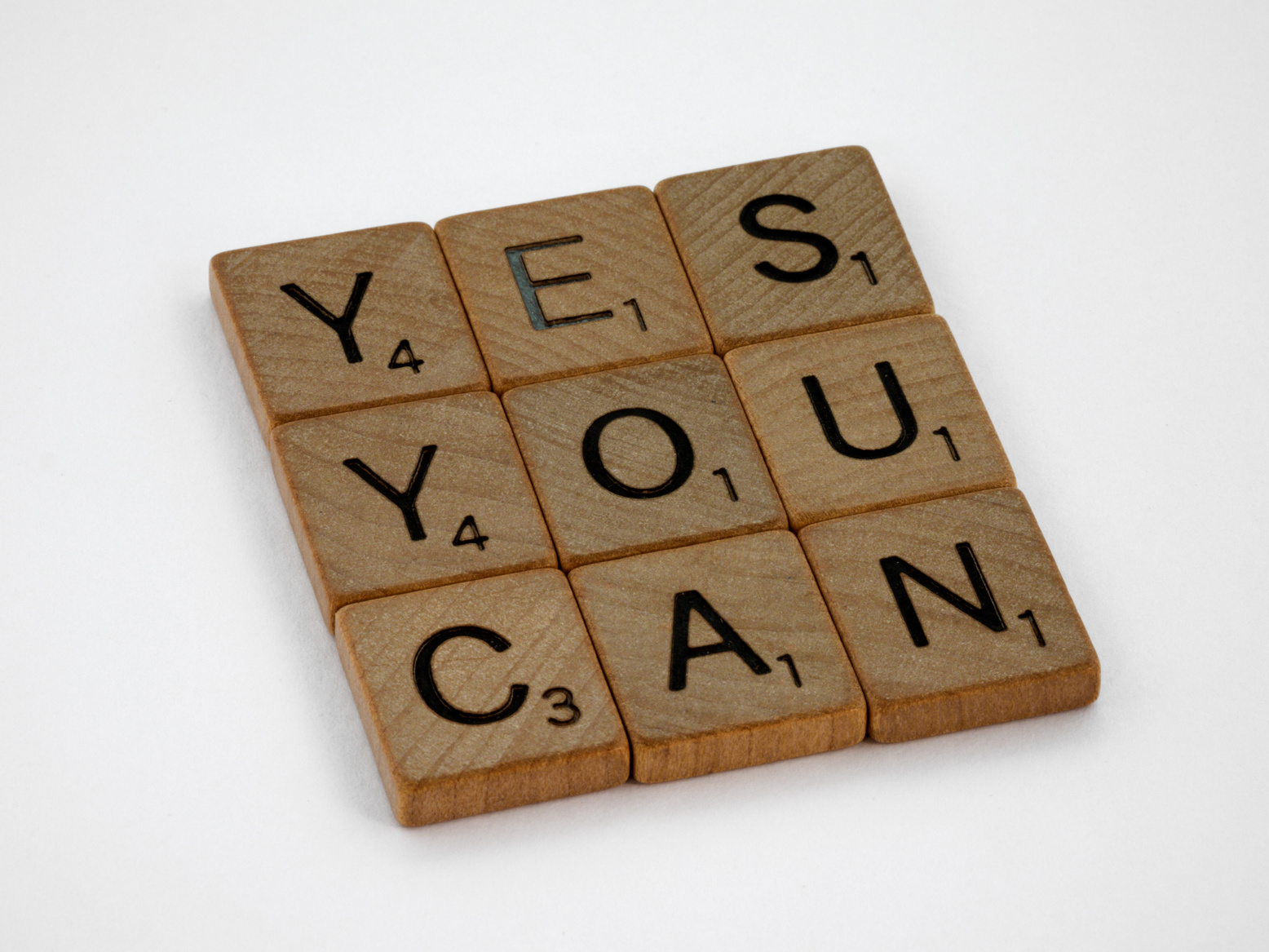 Close-Up Photo of Yes You Can Text on White Surface